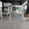 PVC awning windows wrapped and stacked on pallets in factory warehouse