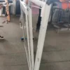 Workers assembling vinyl tilt and turn windows in production line workshop