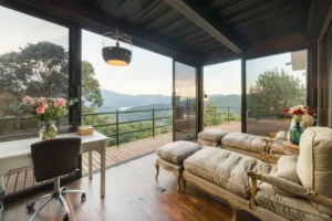 Modern living room with wall-to-wall sliding windows, showing outdoor view and natural light